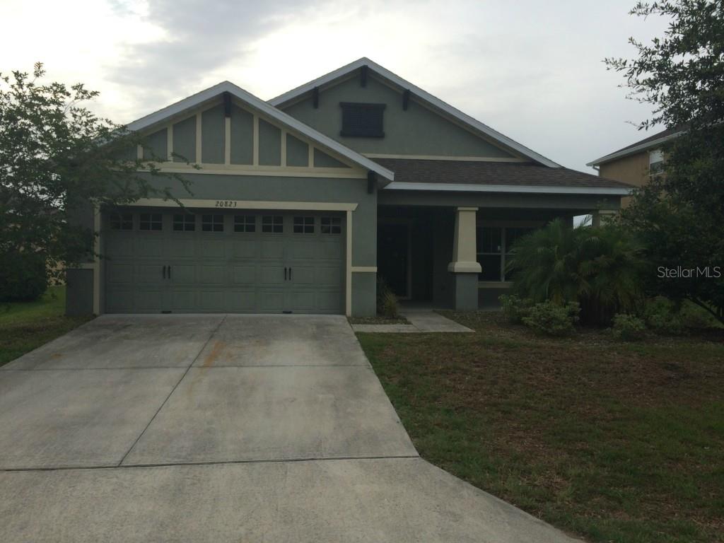 20823 Sullivan Ranch Boulevard Mount Dora, FL 32757 - Photo 1 of 1 a front view of a house with a yard and garage