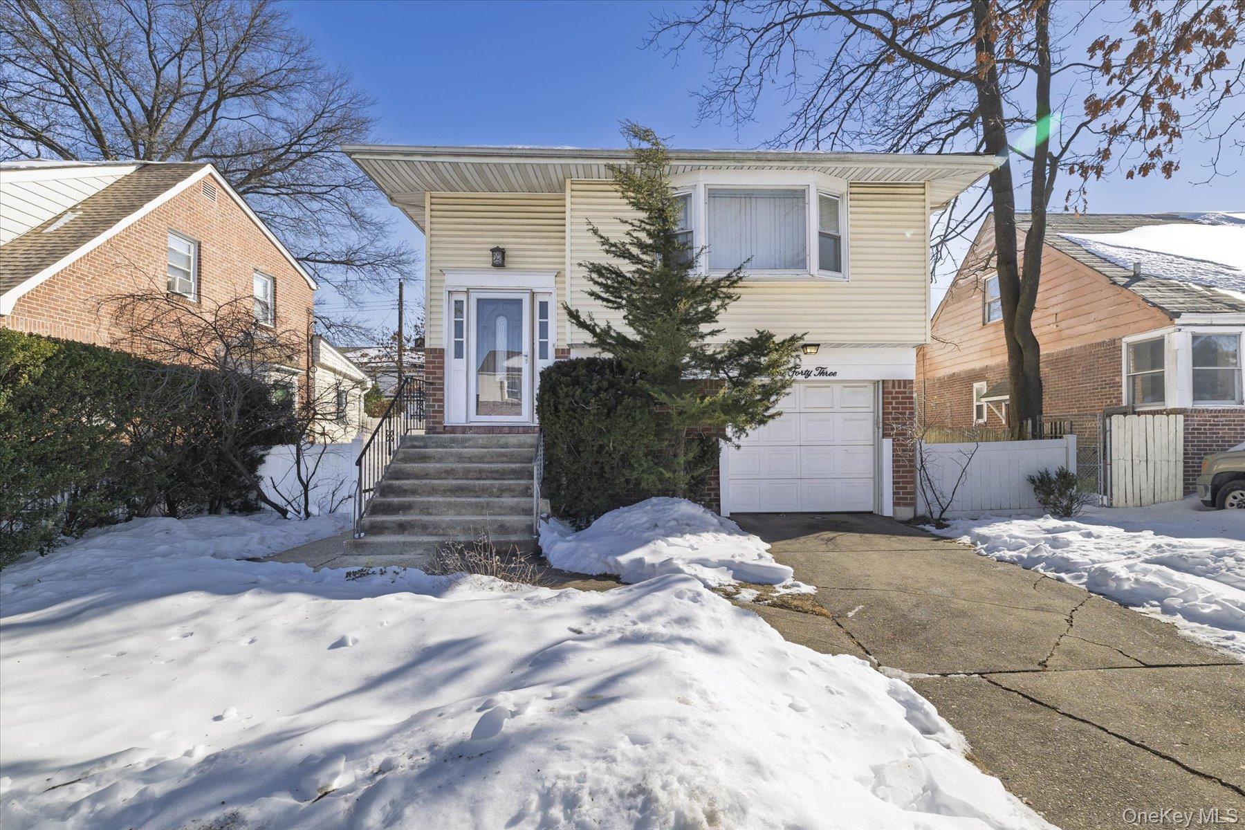 a view of a house with a yard covered in snow