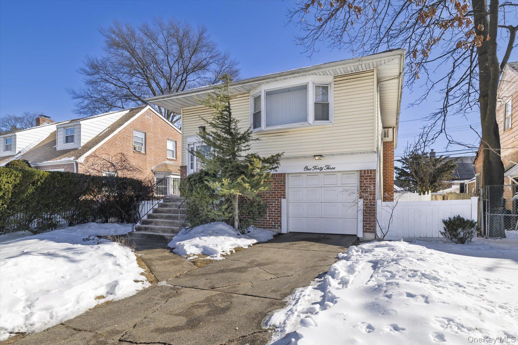 143 Wellington Road Elmont, NY 11003 - Photo 24 of 24 a front view of a house with a yard