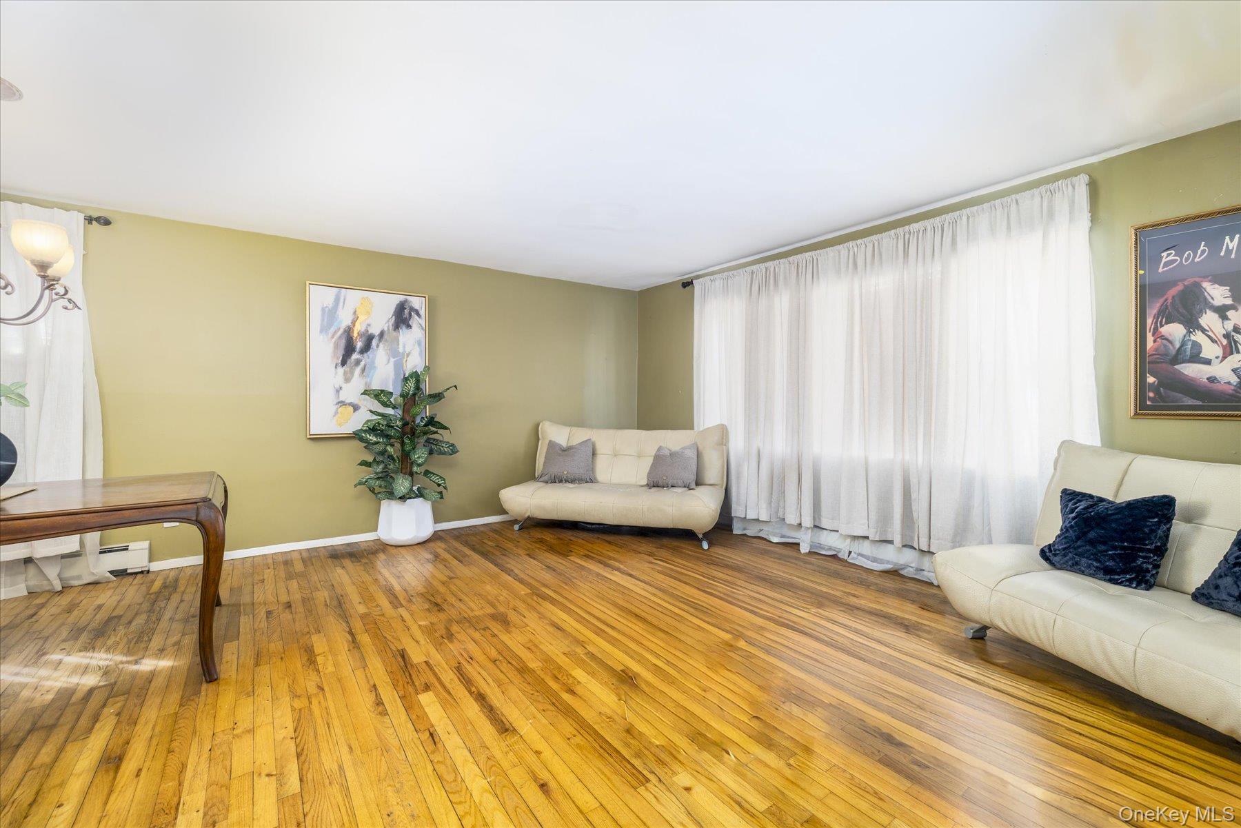 143 Wellington Road Elmont, NY 11003 - Photo 3 of 24 a spacious bedroom with a bed and a cabinets