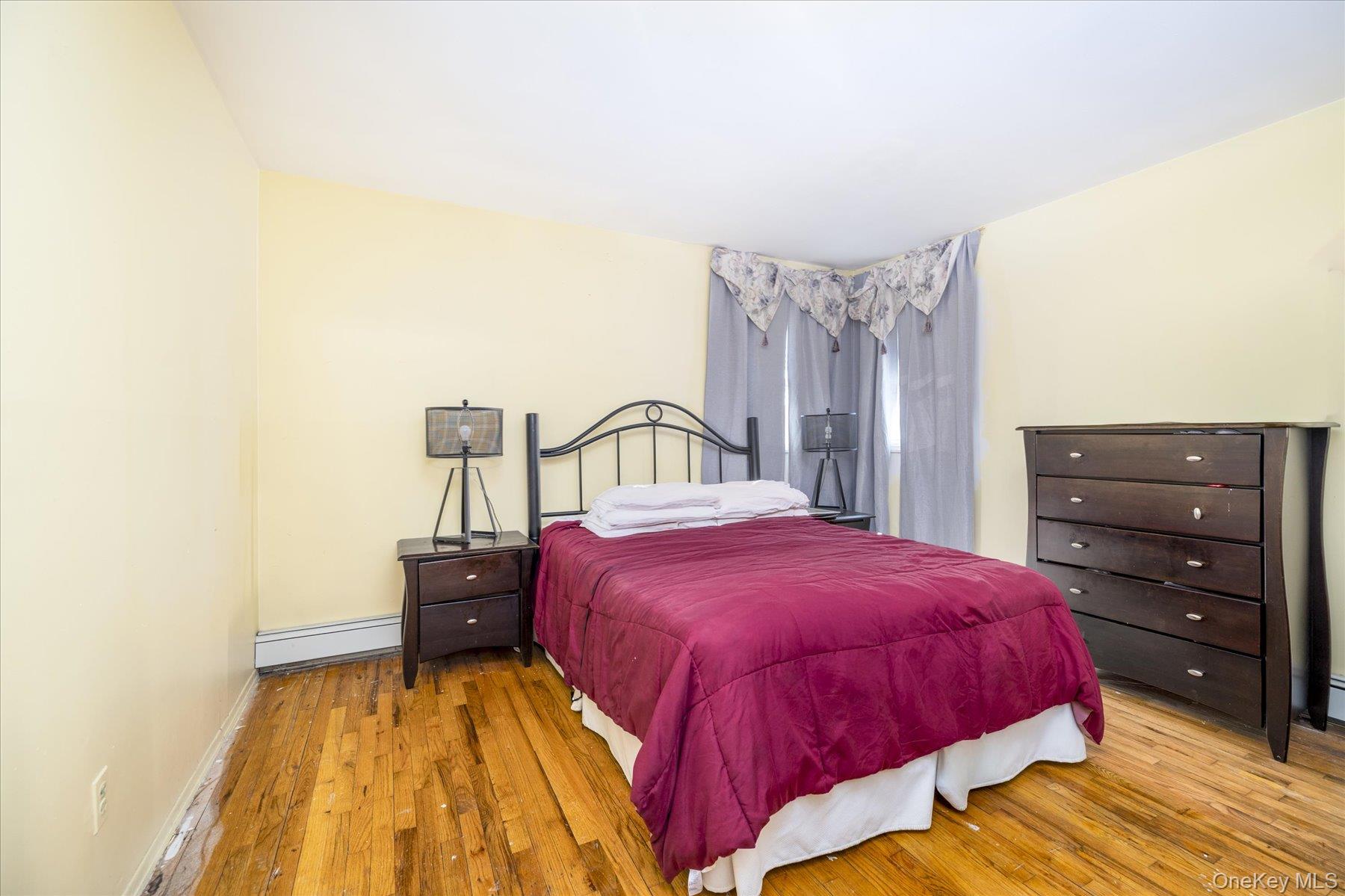 143 Wellington Road Elmont, NY 11003 - Photo 10 of 24 a bedroom with a bed and a dresser