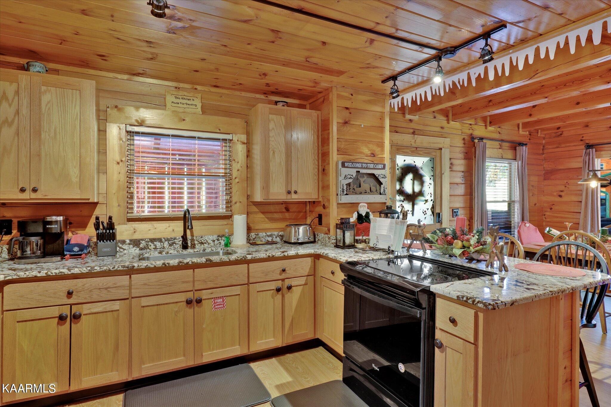 522 Blackberry Rdg Way Sevierville, TN 37863 - Photo 11 of 48 a kitchen with a sink stove and cabinets