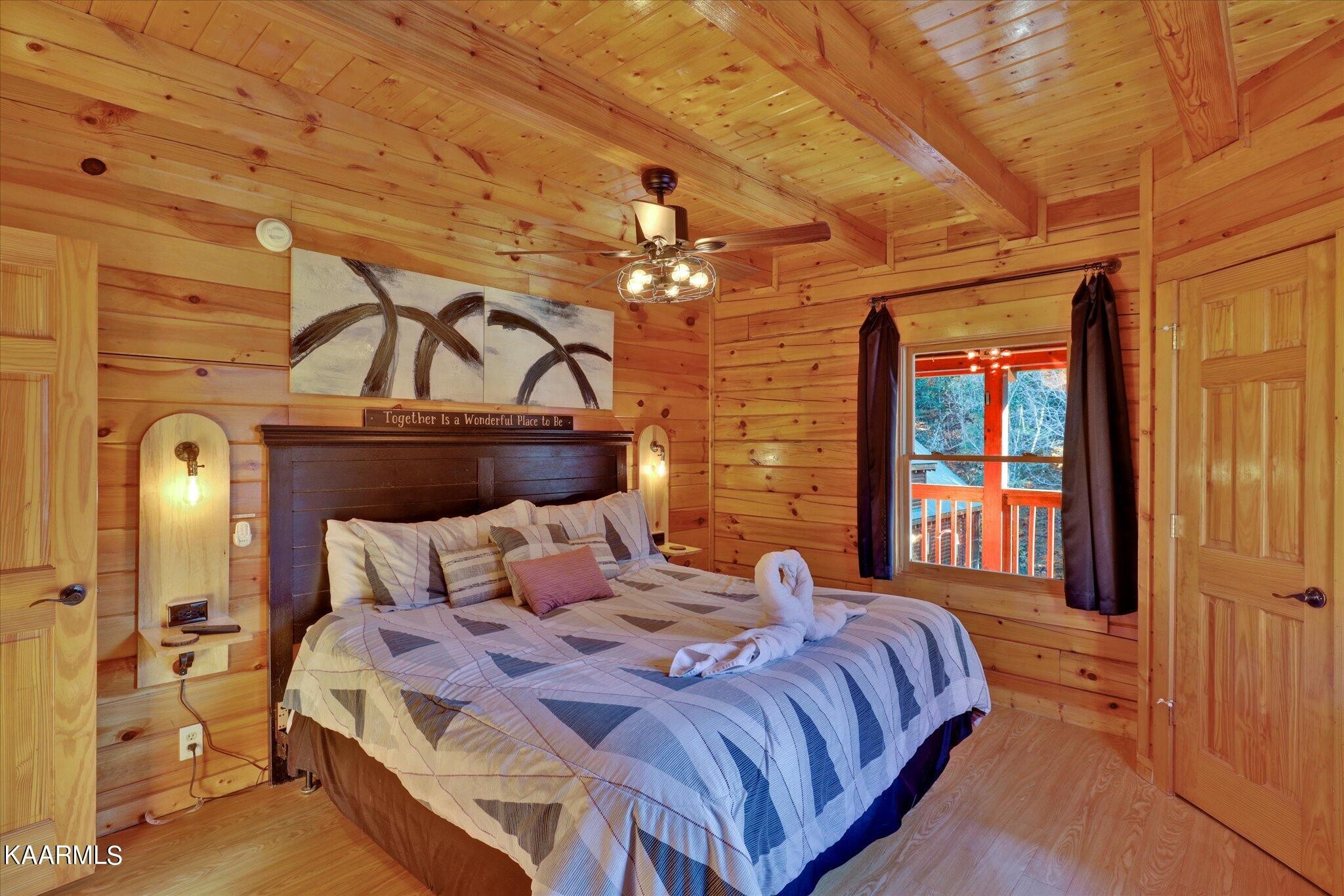 522 Blackberry Rdg Way Sevierville, TN 37863 - Photo 16 of 48 a bedroom with a bed a dresser and window