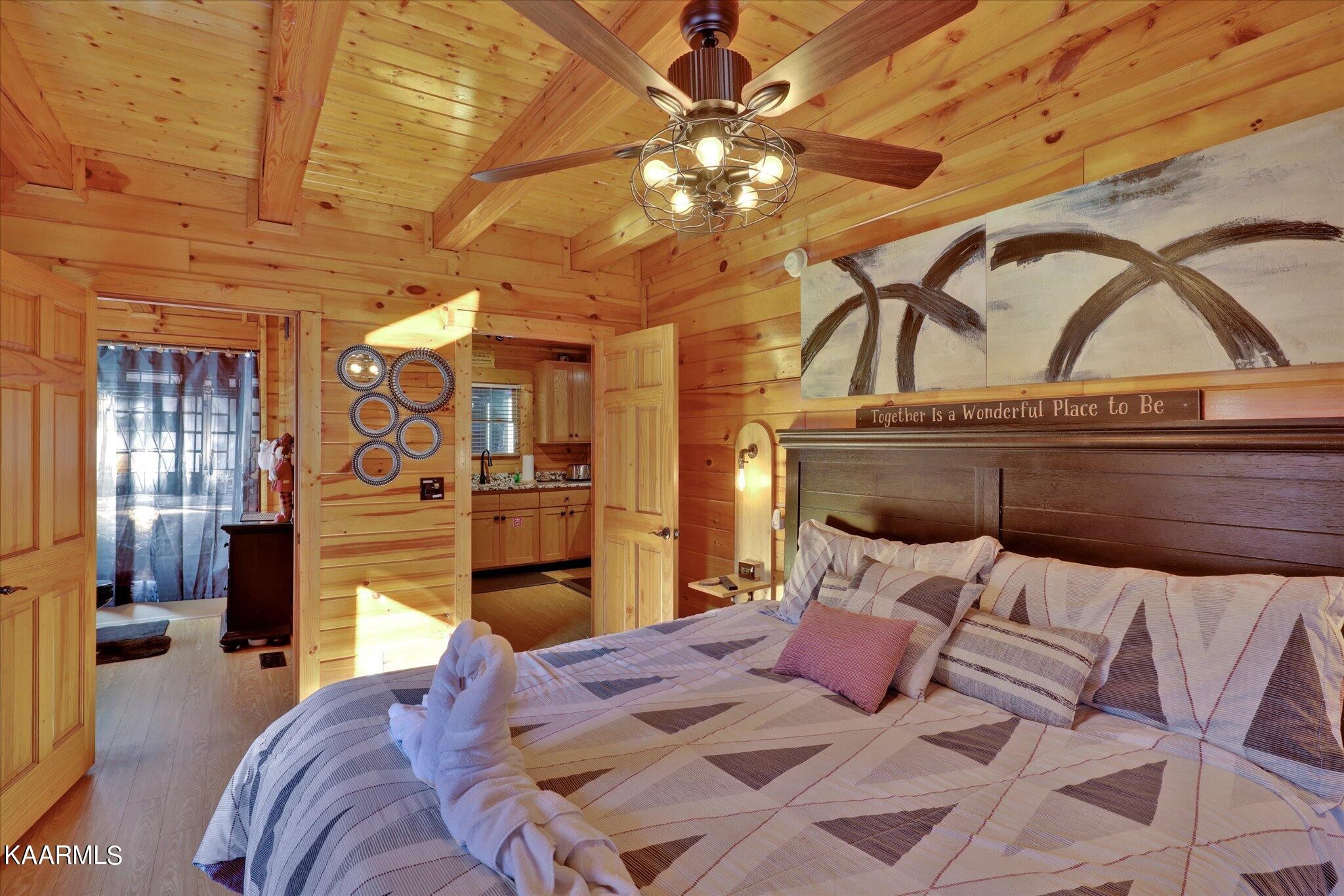 522 Blackberry Rdg Way Sevierville, TN 37863 - Photo 17 of 48 a bedroom with a bed and a chandelier