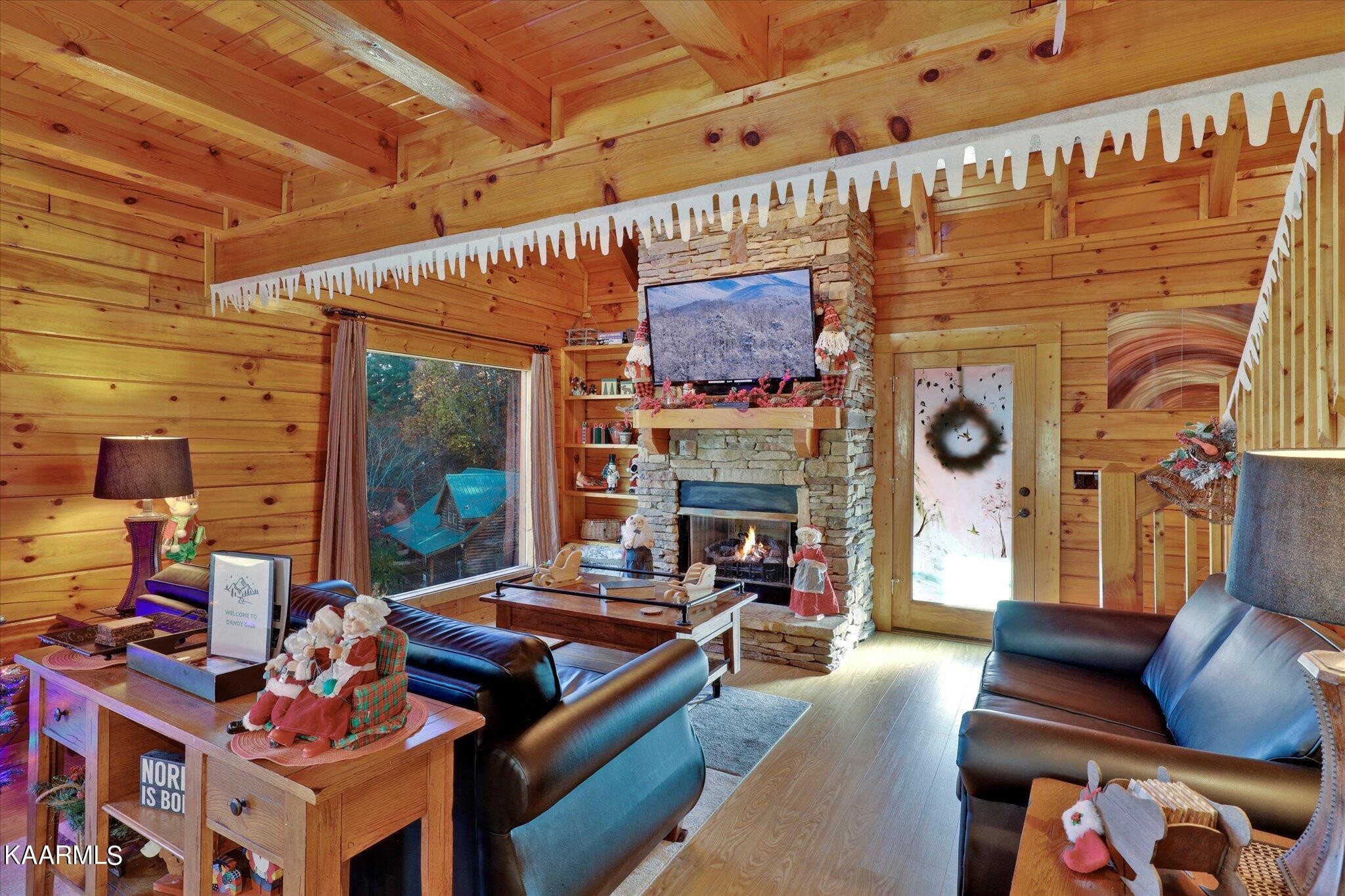 522 Blackberry Rdg Way Sevierville, TN 37863 - Photo 2 of 48 a living room with furniture a fireplace and a table
