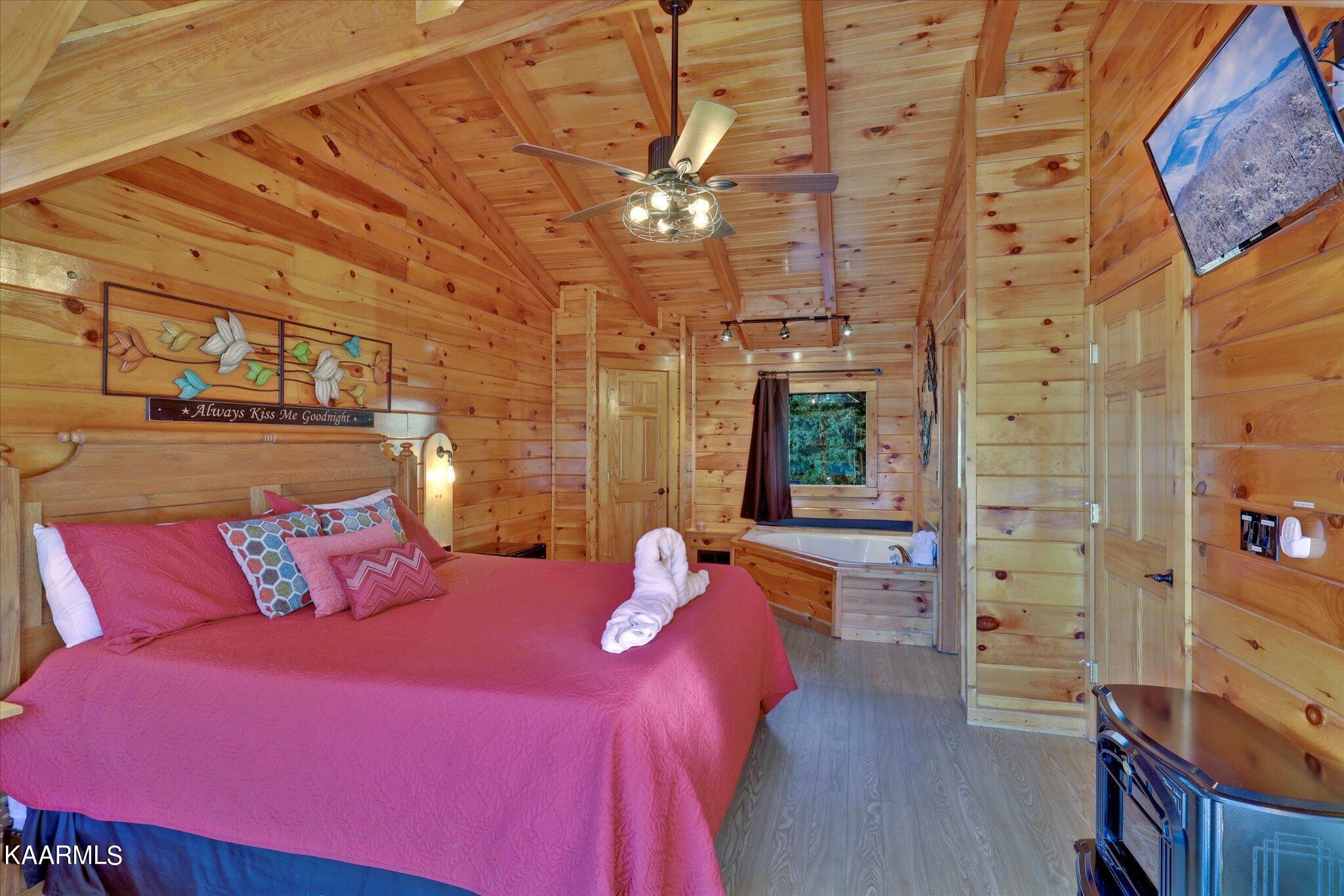 522 Blackberry Rdg Way Sevierville, TN 37863 - Photo 27 of 48 a bedroom with a bed a chandelier and dresser