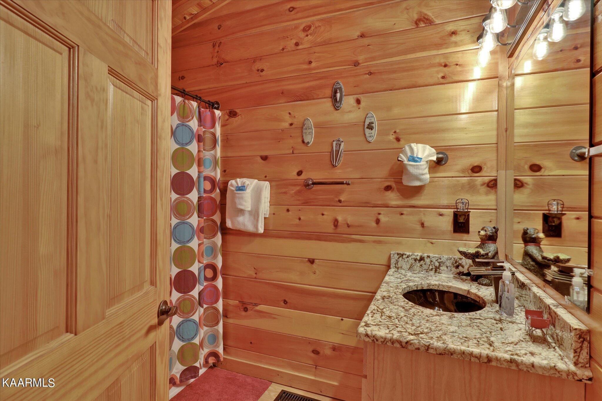 522 Blackberry Rdg Way Sevierville, TN 37863 - Photo 30 of 48 a bathroom with a sink and a shower curtain