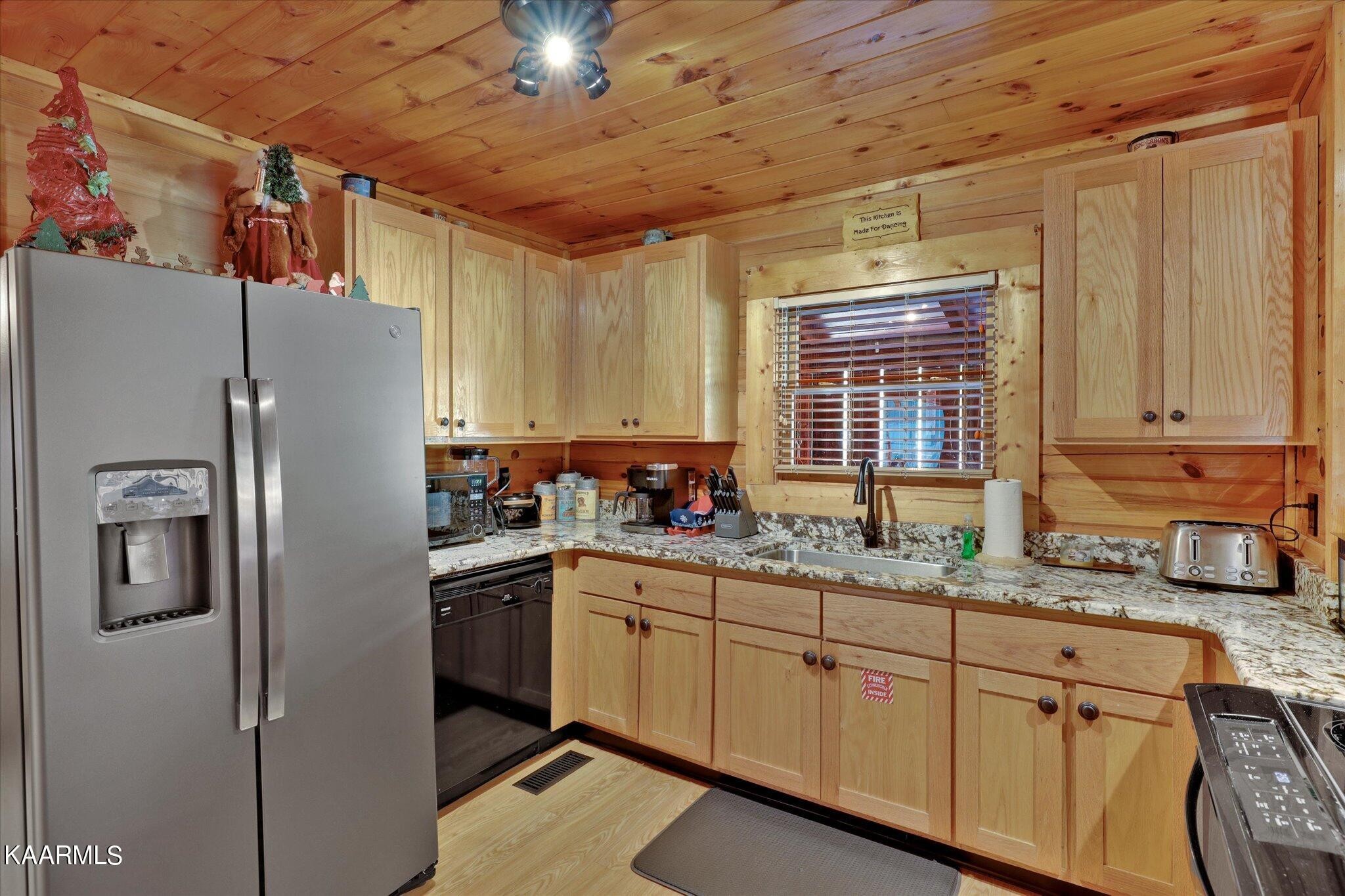 522 Blackberry Rdg Way Sevierville, TN 37863 - Photo 10 of 48 a kitchen with stainless steel appliances a refrigerator sink and cabinets