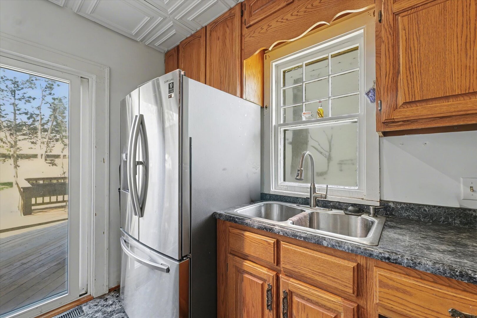 248 East Fremont Street Bement, IL 61813 - Photo 11 of 40 a kitchen with stainless steel appliances granite countertop a refrigerator and a sink