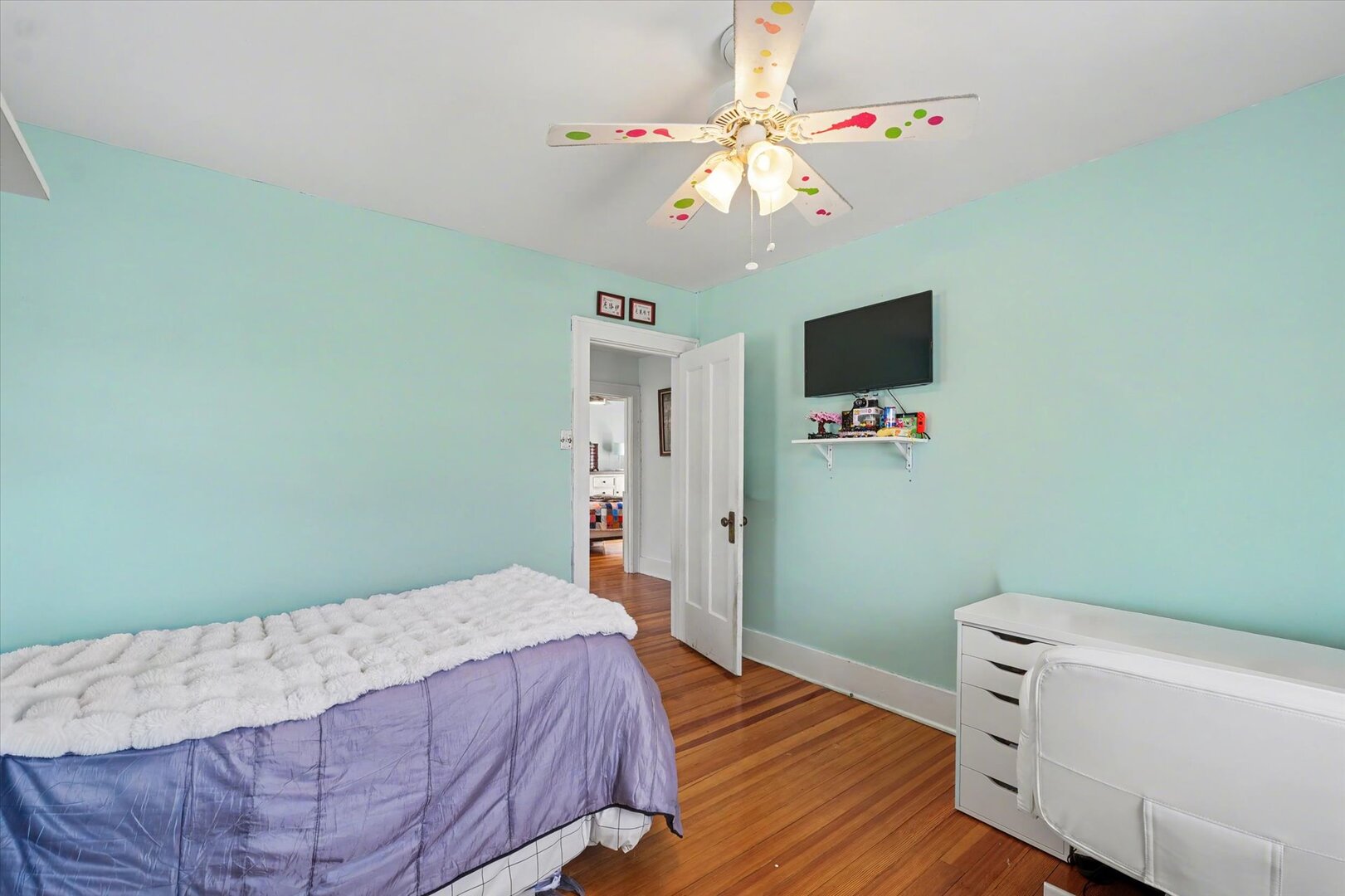 248 East Fremont Street Bement, IL 61813 - Photo 21 of 40 a bedroom with a bed and a chandelier