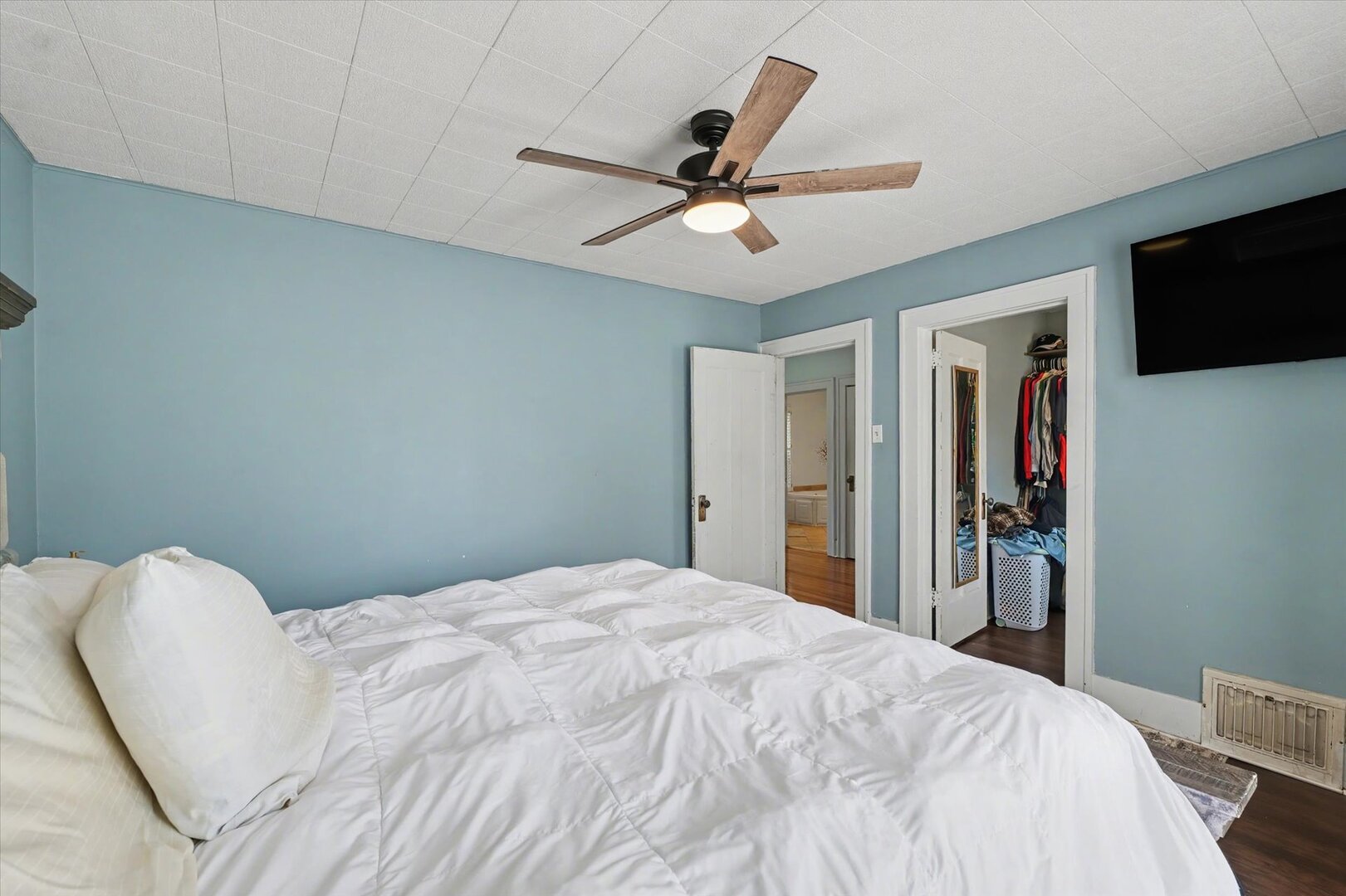 248 East Fremont Street Bement, IL 61813 - Photo 26 of 40 a bedroom with a large bed and a ceiling fan