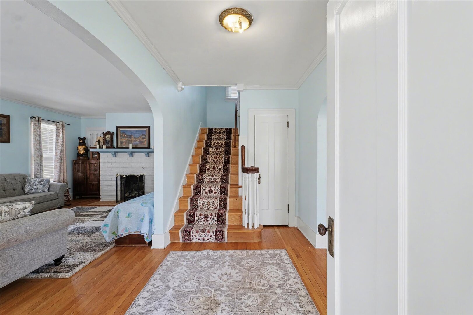 248 East Fremont Street Bement, IL 61813 - Photo 3 of 40 a view of a bedroom with wooden floor and stairs