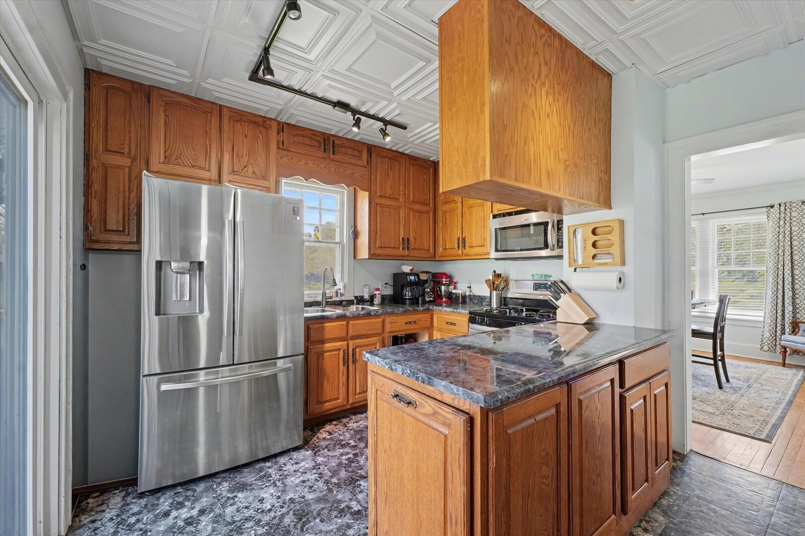248 East Fremont Street Bement, IL 61813 - Photo 8 of 40 a kitchen with stainless steel appliances granite countertop a refrigerator a stove and a sink