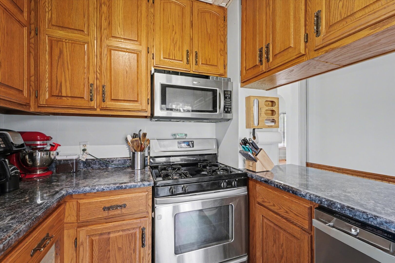 248 East Fremont Street Bement, IL 61813 - Photo 9 of 40 a kitchen with granite countertop cabinets stainless steel appliances and a counter space