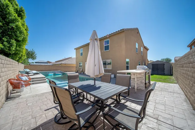 a view of a backyard with sitting area