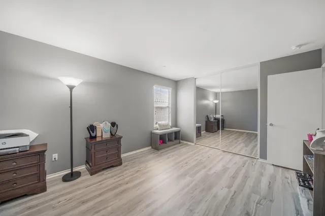 a view of hallway with stairs and wooden floor