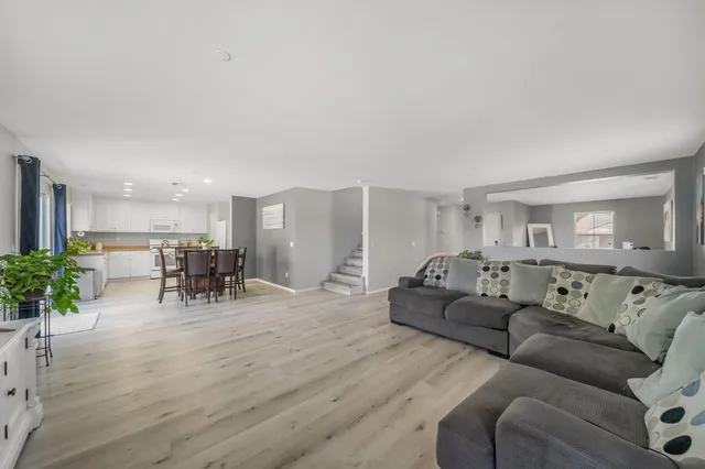 a spacious bedroom with a bed and wooden floor