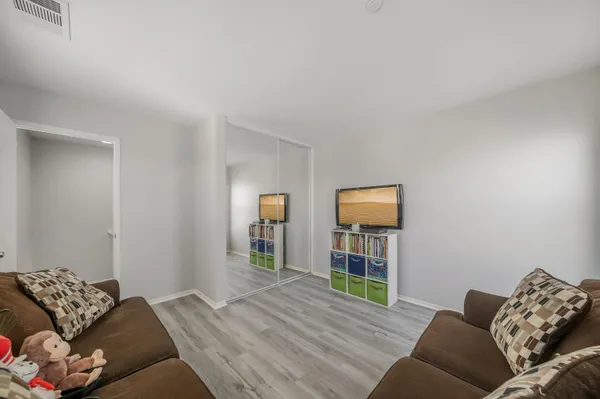 a bedroom with a bed and wooden floor