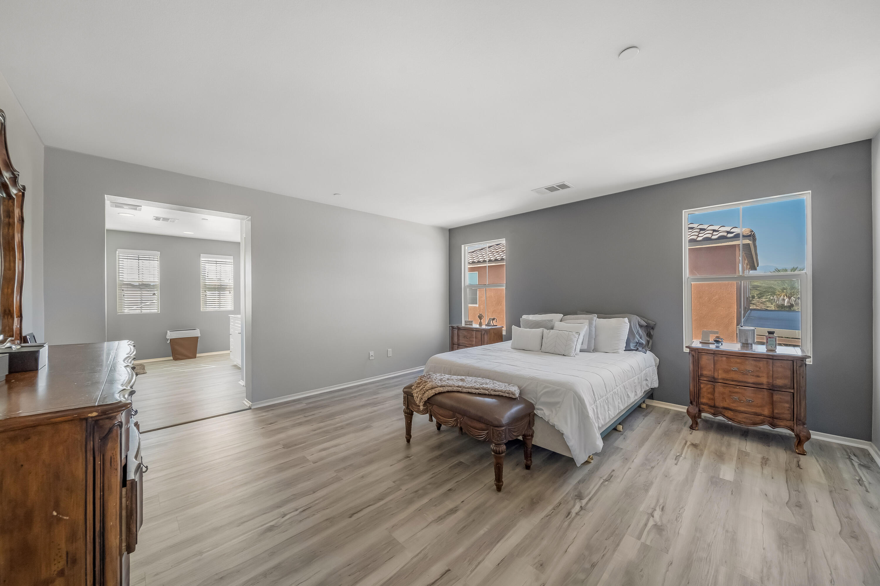 84030 Manhattan Avenue Coachella, CA 92236 - Photo 45 of 74 a spacious bedroom with a bed and wooden floor
