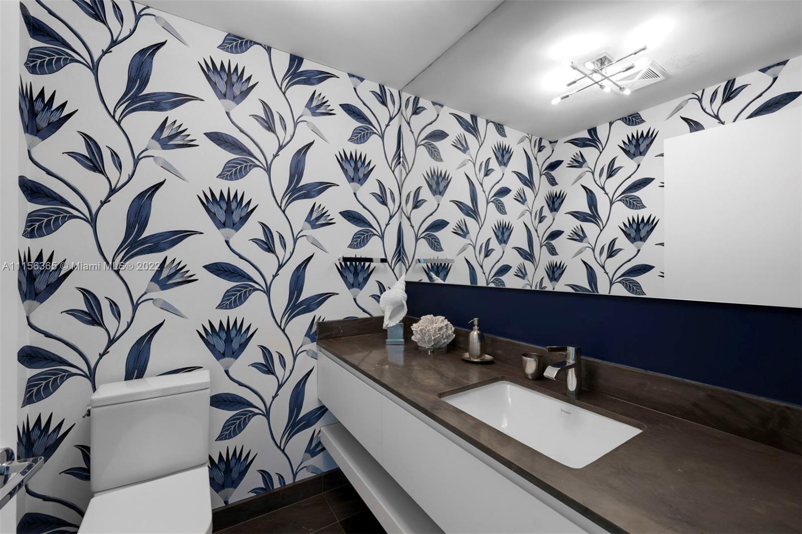 360 Ocean Drive, Unit 1101S Key Biscayne, FL 33149 - Photo 22 of 65 a bathroom with a granite countertop sink and a mirror