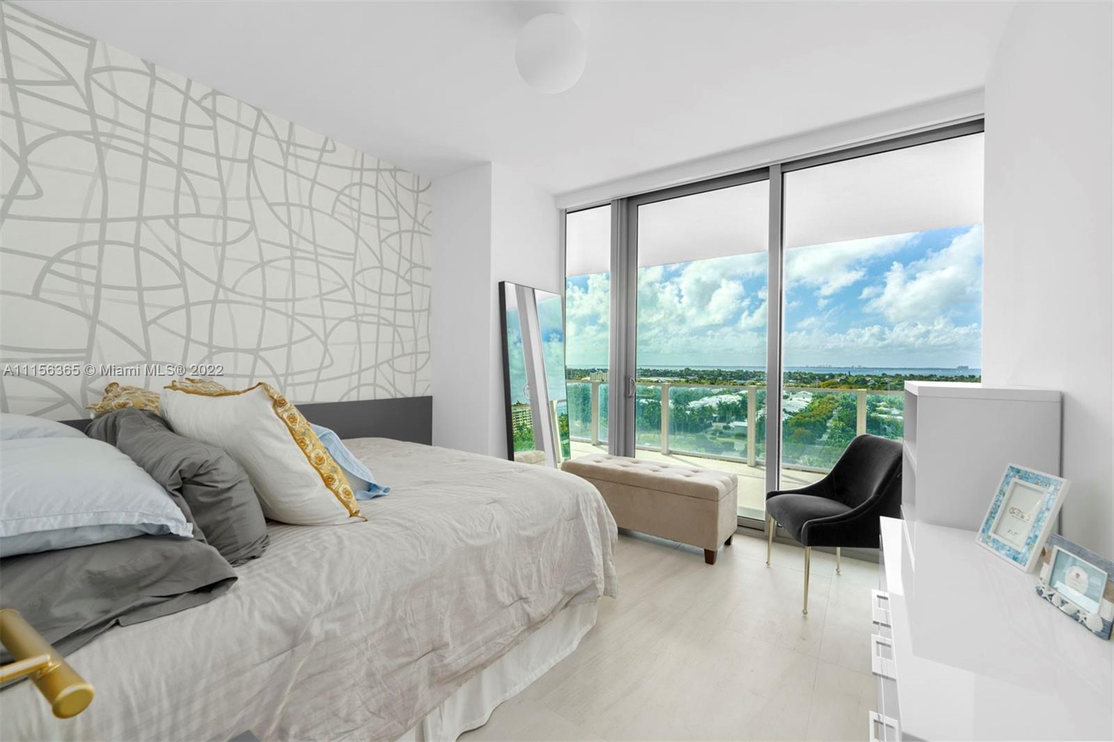 360 Ocean Drive, Unit 1101S Key Biscayne, FL 33149 - Photo 27 of 65 a spacious bedroom with a bed and a large window