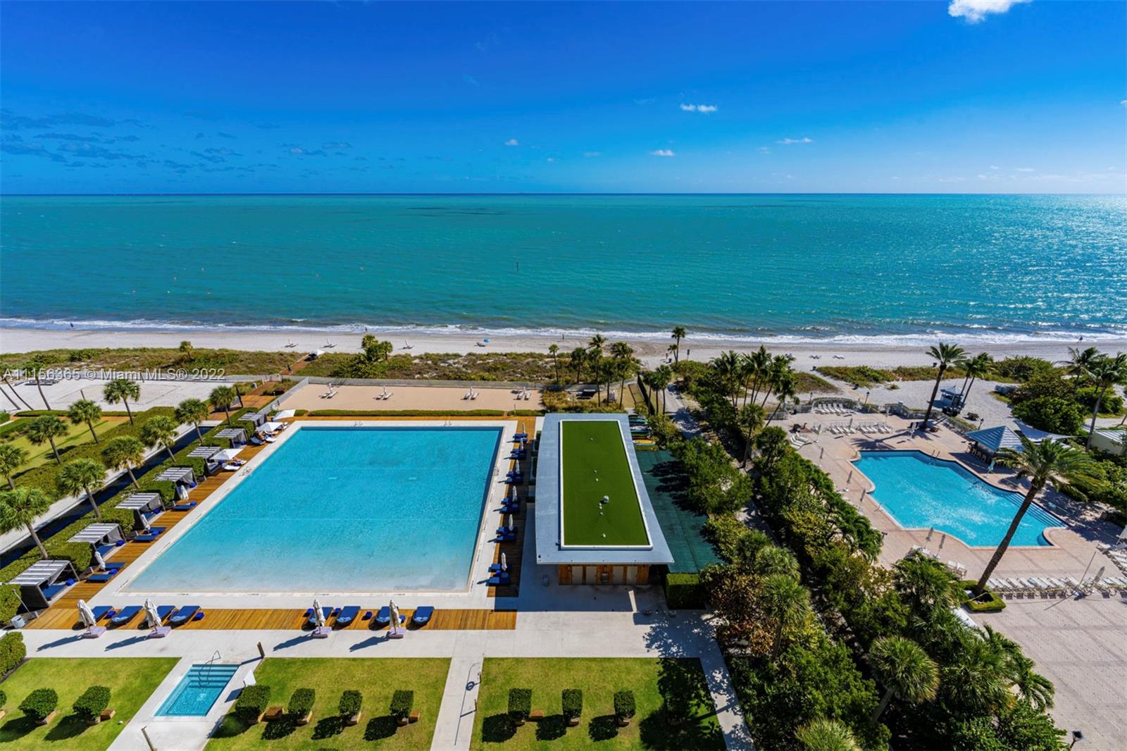 360 Ocean Drive, Unit 1101S Key Biscayne, FL 33149 - Photo 42 of 65 a view of a tennis ground with a table and chairs