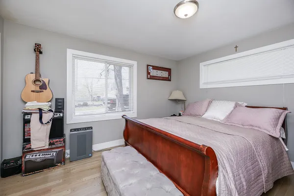 a bedroom with a bed and a chandelier