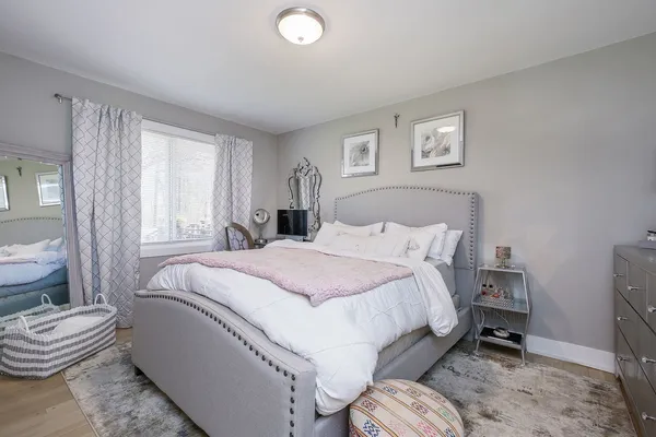 a bedroom with a bed and a chair