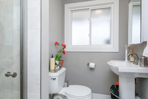 a bathroom with a sink a toilet and a mirror