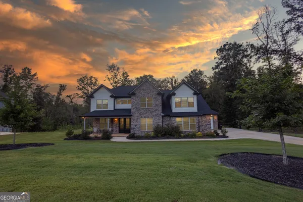 a front view of a house with a yard