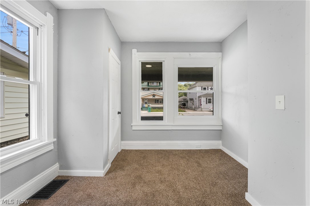 885 Wales Road Northeast Massillon, OH 44646 - Photo 29 of 34 Interior space featuring light gray wall paint, white trim, and brown carpet flooring