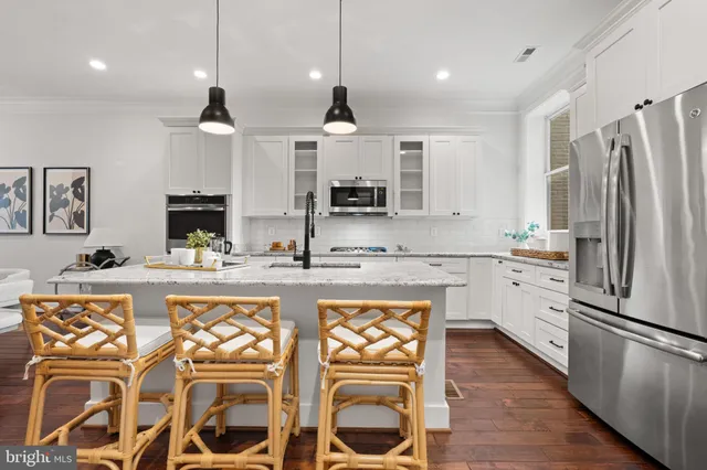a kitchen with a stove and wooden floor