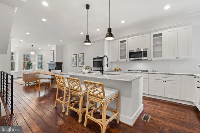 a living room with furniture a fireplace and kitchen view