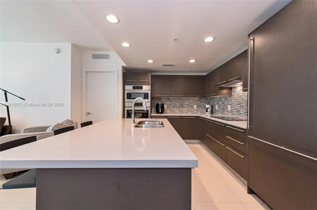 a large white kitchen with a large window