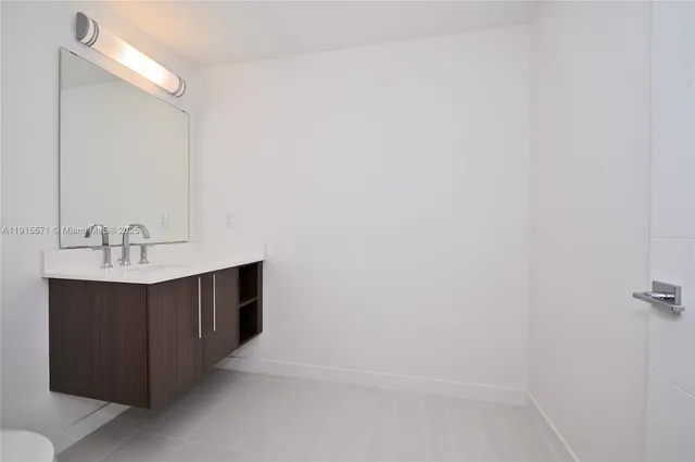 a bathroom with a sink vanity and a mirror