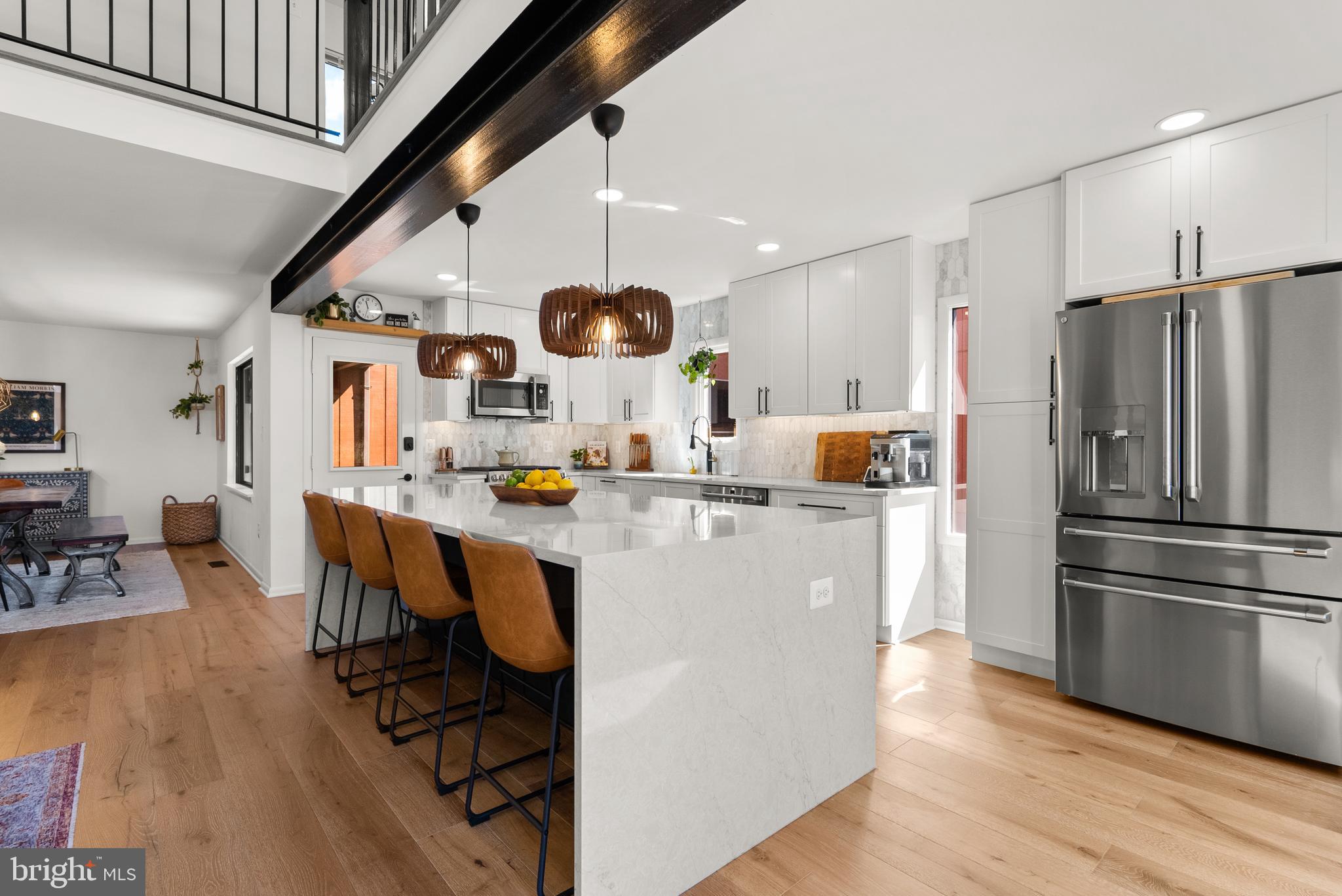 5213 Bradfield Drive Burke, VA 22015 - Photo 4 of 48 a kitchen with stainless steel appliances kitchen island granite countertop a refrigerator a oven a stove and a dining table with wooden floor