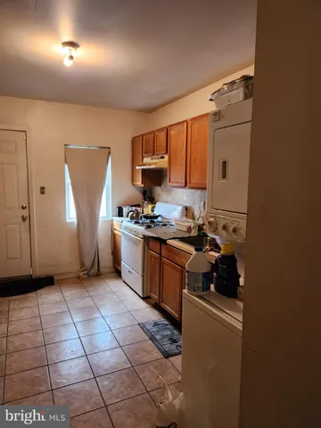 a kitchen with a sink a stove and cabinets