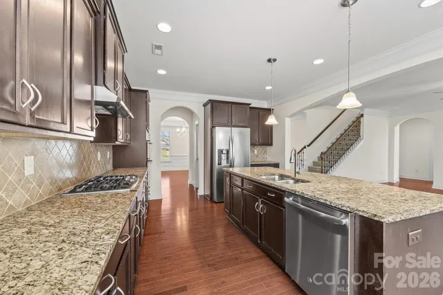 a kitchen with granite countertop a stove and cabinets