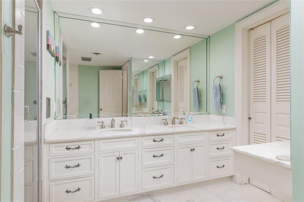 6126 Averill Way, Unit 103W Dallas, TX 75225 - Photo 18 of 34 a bathroom with a double vanity sink mirror double and shower