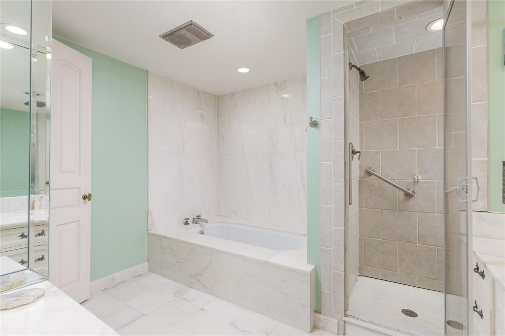 6126 Averill Way, Unit 103W Dallas, TX 75225 - Photo 19 of 34 a bathroom with a bathtub and a shower