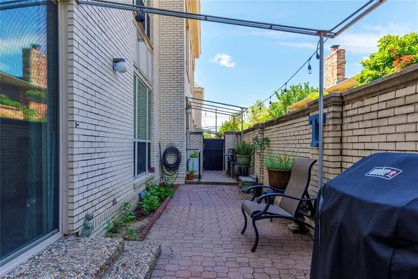 a backyard of a house with a table and chairs