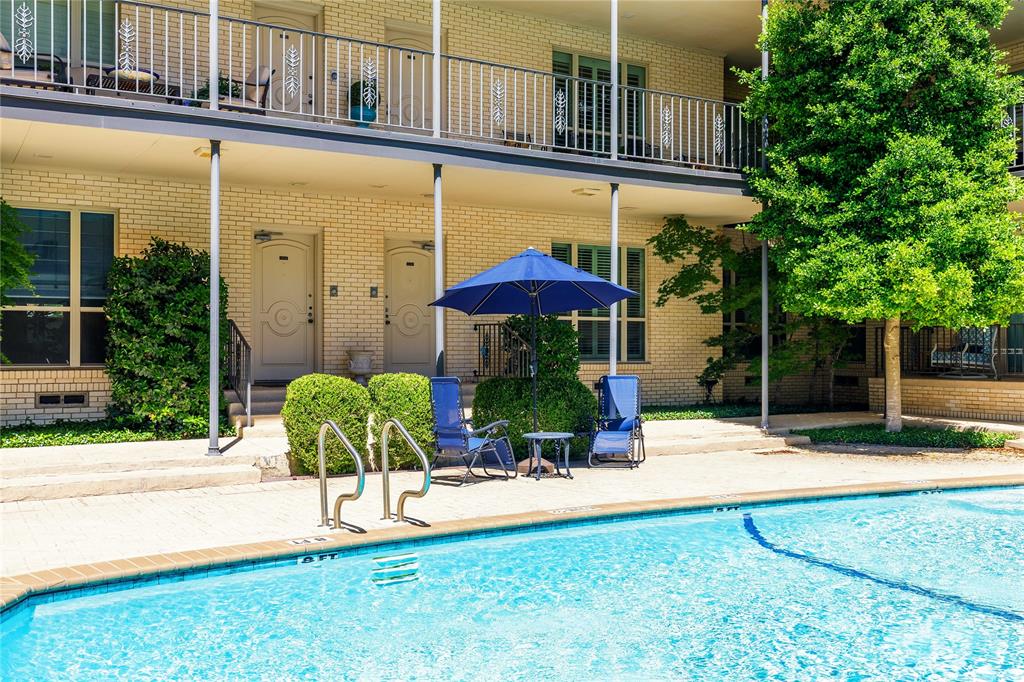 6126 Averill Way, Unit 103W Dallas, TX 75225 - Photo 31 of 34 a view of a table and chairs under an umbrella