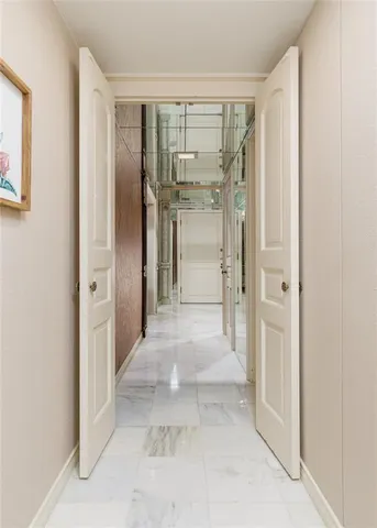 a view of a hallway with wooden shelves