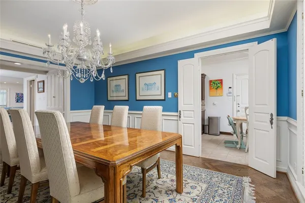a view of a dining room with furniture and chandelier
