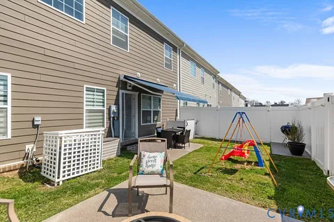 a backyard view of a house and outdoor seating