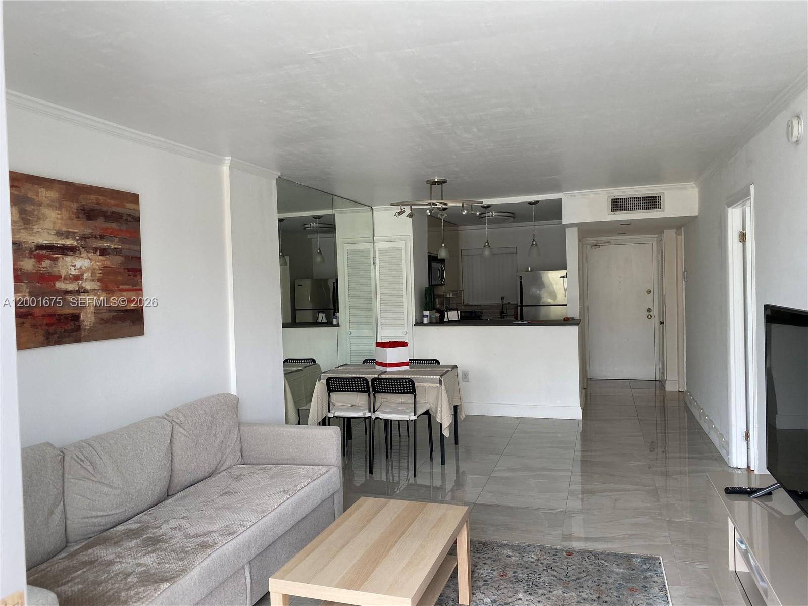 1345 Lincoln Road, Unit 704 Miami Beach, FL 33139 - Photo 4 of 17 a living room with furniture and kitchen view