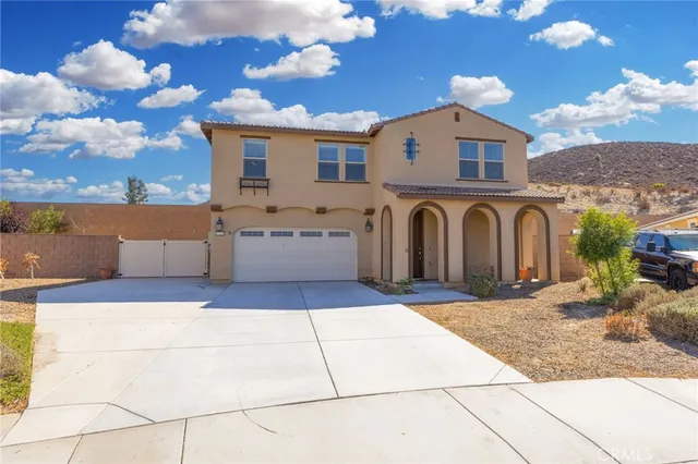 a kitchen with stainless steel appliances granite countertop a sink a stove and a wooden floor
