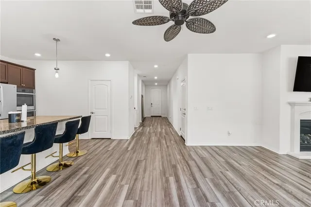 a kitchen with stainless steel appliances kitchen island granite countertop a sink and cabinets