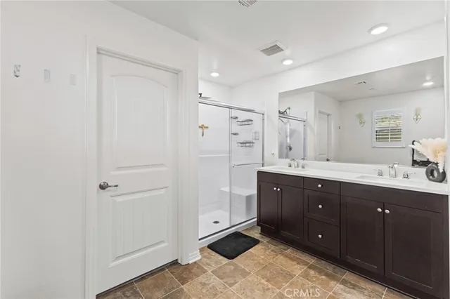 a spacious bathroom with a granite countertop sink toilet and a mirror