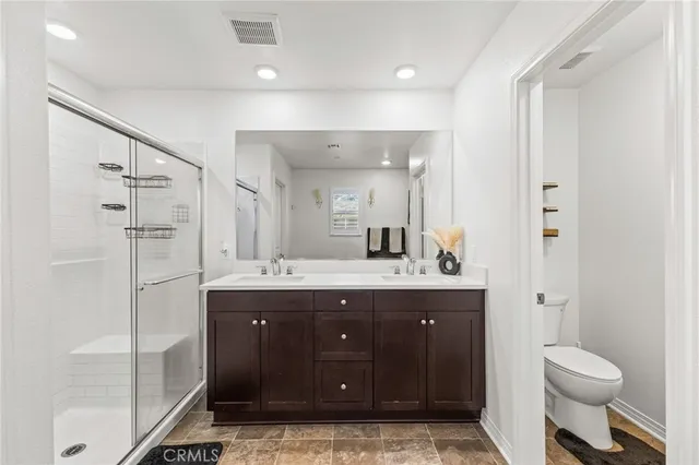 a bathroom with a sink double vanity and shower